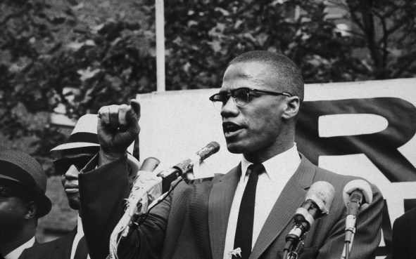 circa 1963: American civil rights leader Malcolm X (1925 - 1965) at an outdoor rally, probably in New York City. (Photo by Bob Parent/Hulton Archive/Getty Images)